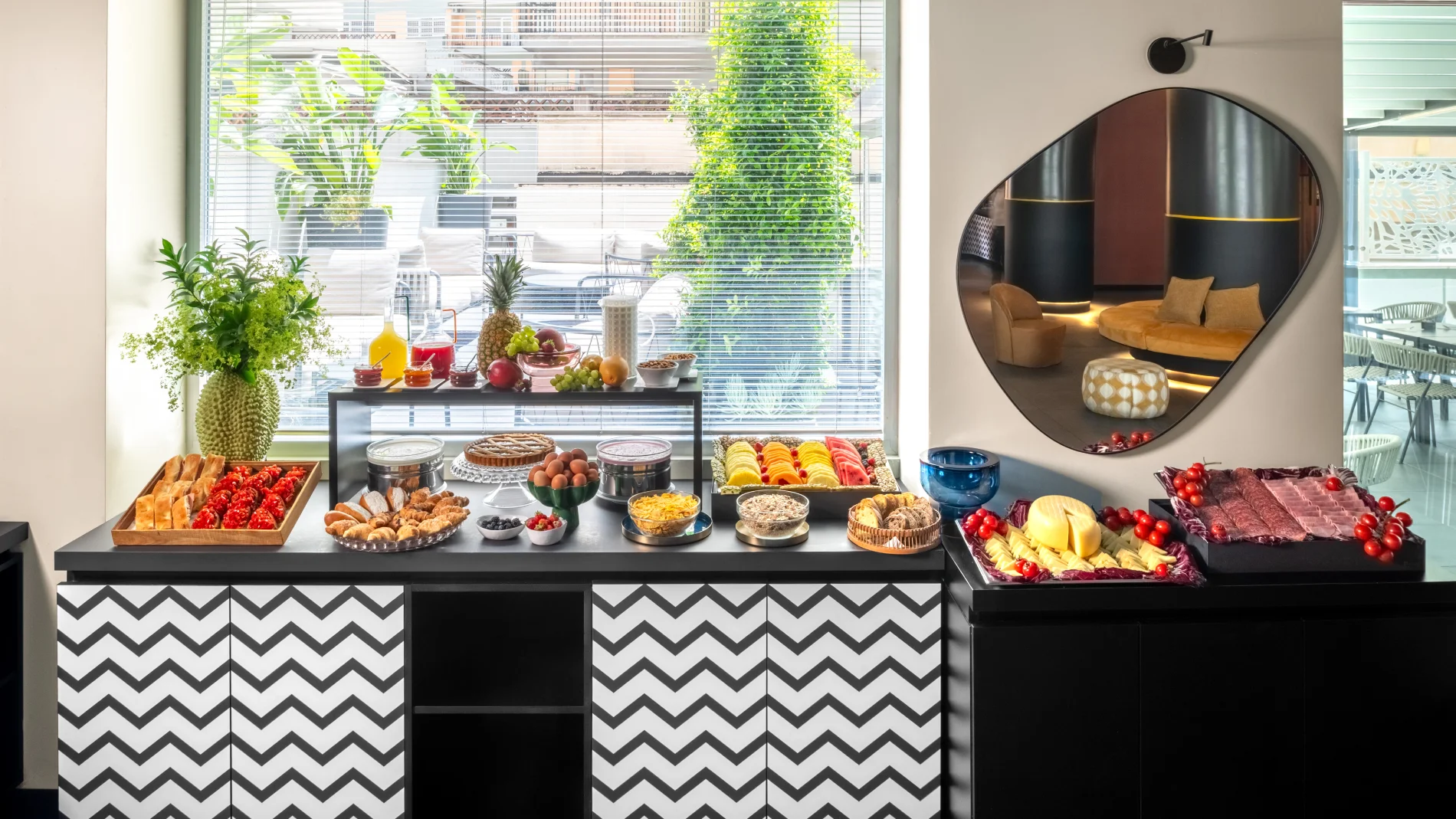 Breakfast buffet with fruit, pastries, cold cuts and cheese in a bright room with terrace view - Aparthotel Colombo, BZAR hotels in Rome