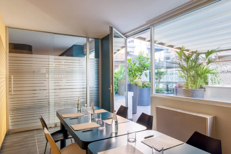 Bright meeting room with equipped table, glass walls and green terrace for business meetings - Aparthotel Colombo, BZAR hotels in Rome