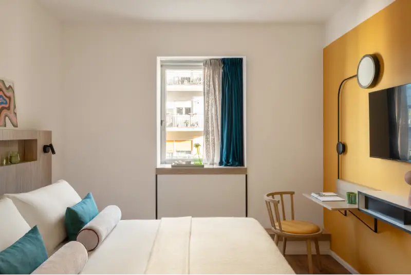 Superior room with double bed, mustard wall, TV and compact desk - Aparthotel Colombo, BZAR hotels in Rome